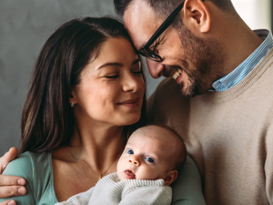 mother and father holding their baby