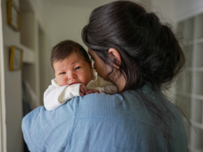 Mother holding upset baby