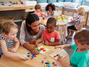 Teacher and children sitting around a table