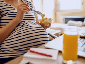 Pregnant woman eating banana